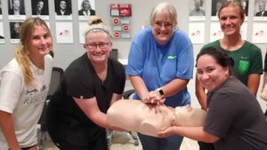 Group CPR training session in Chicago with instructor and students.